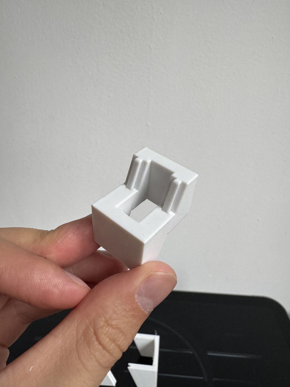 A hand holding the chosen dovetail joint, the two enclosure halves engaged