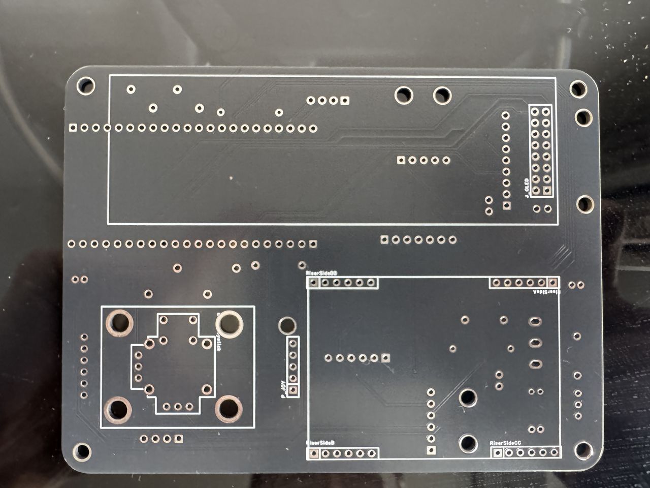 The bare main PCB, revision 2, front face, showing the through-hole footprints and module headers