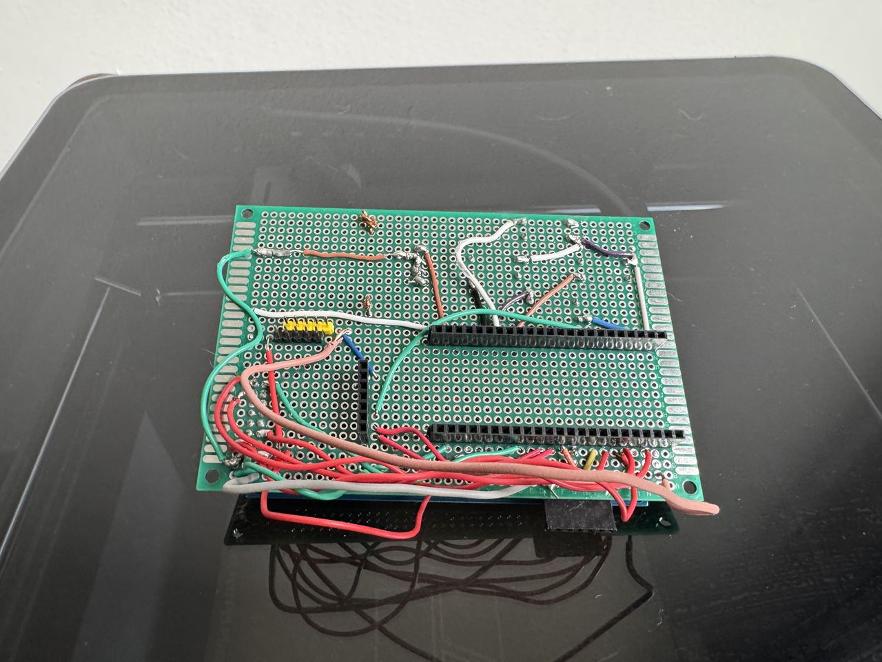 The hand-wired perfboard, before any module is seated