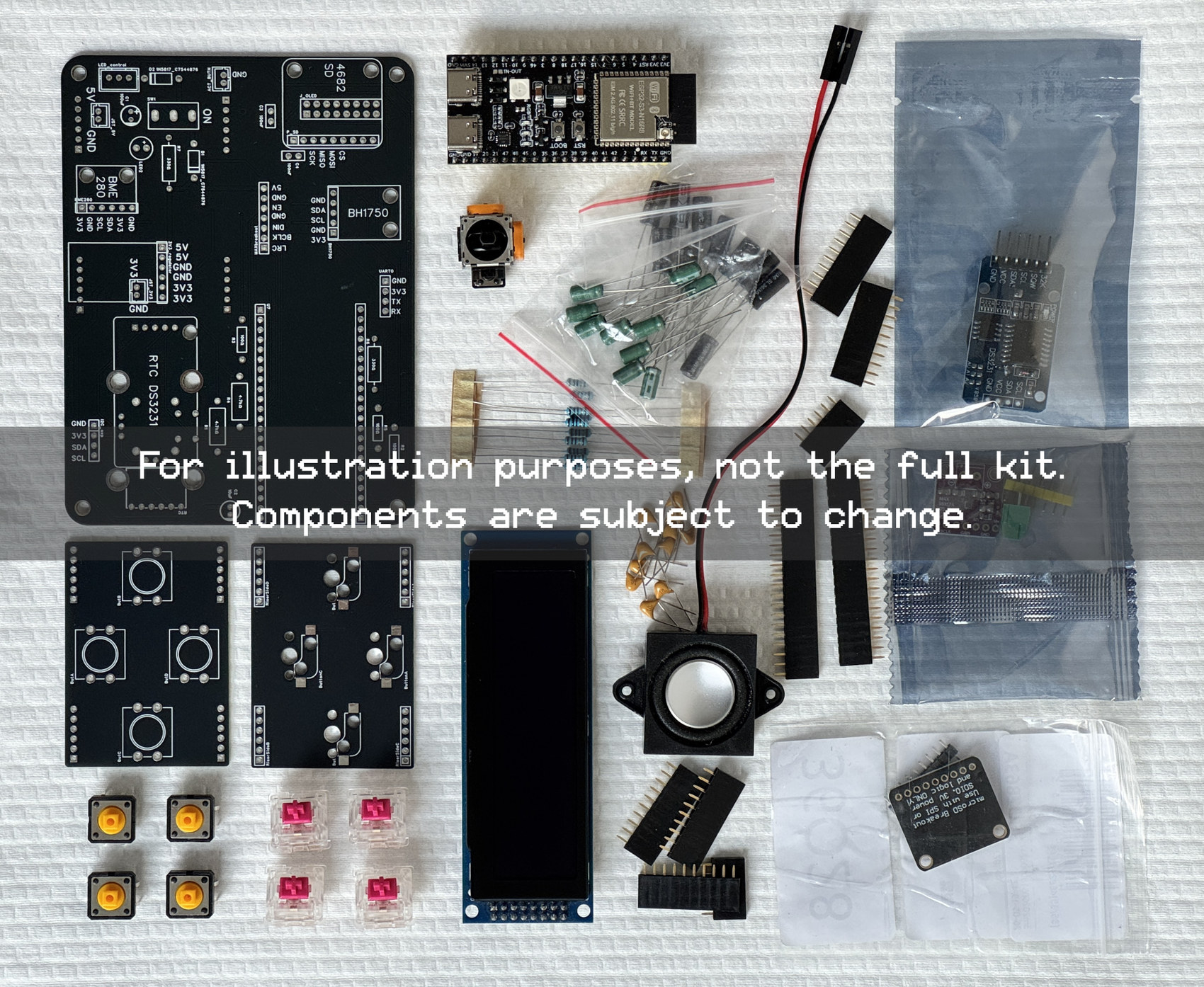 Overhead layout of every part in the CinderClock DIY Kit: the custom PCB, the display, the audio and power modules, the dome button, the joystick and the passive components